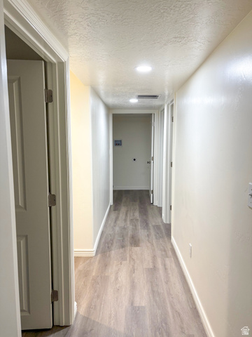 1666 West Foxberry Road Santaquin, UT 84655 - Photo 21 of 23 Corridor with a textured ceiling and light wood-type flooring