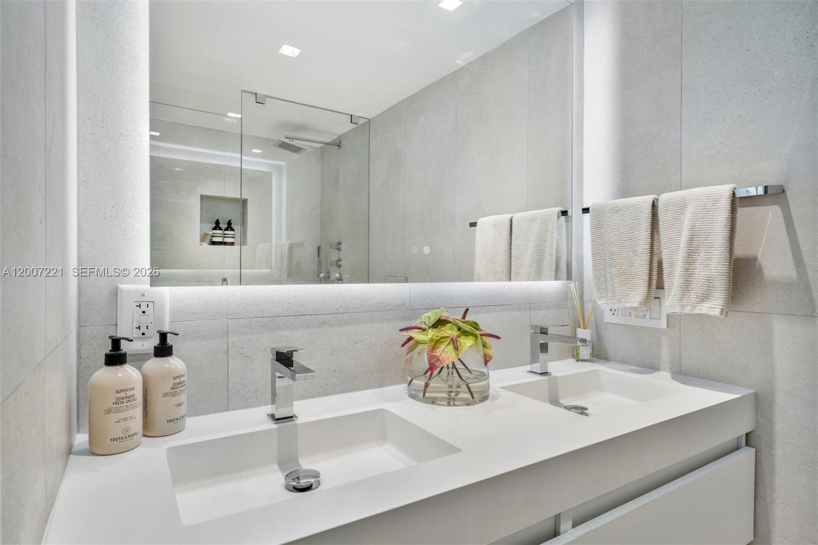 2301 Collins Avenue, Unit 902 Miami Beach, FL 33139 - Photo 14 of 22 a bathroom with a sink and a mirror