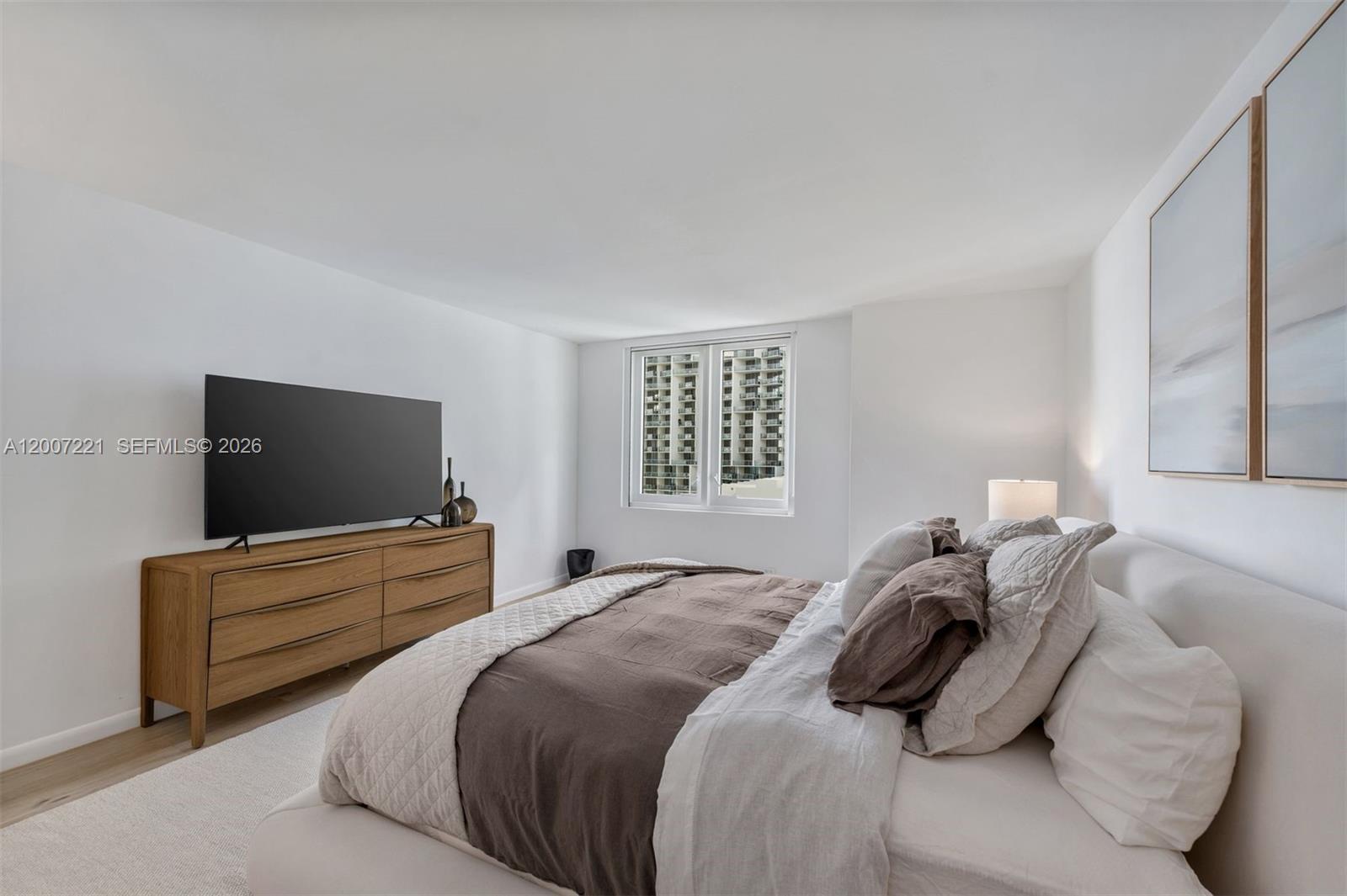 2301 Collins Avenue, Unit 902 Miami Beach, FL 33139 - Photo 17 of 22 a bedroom with a bed and flat screen tv