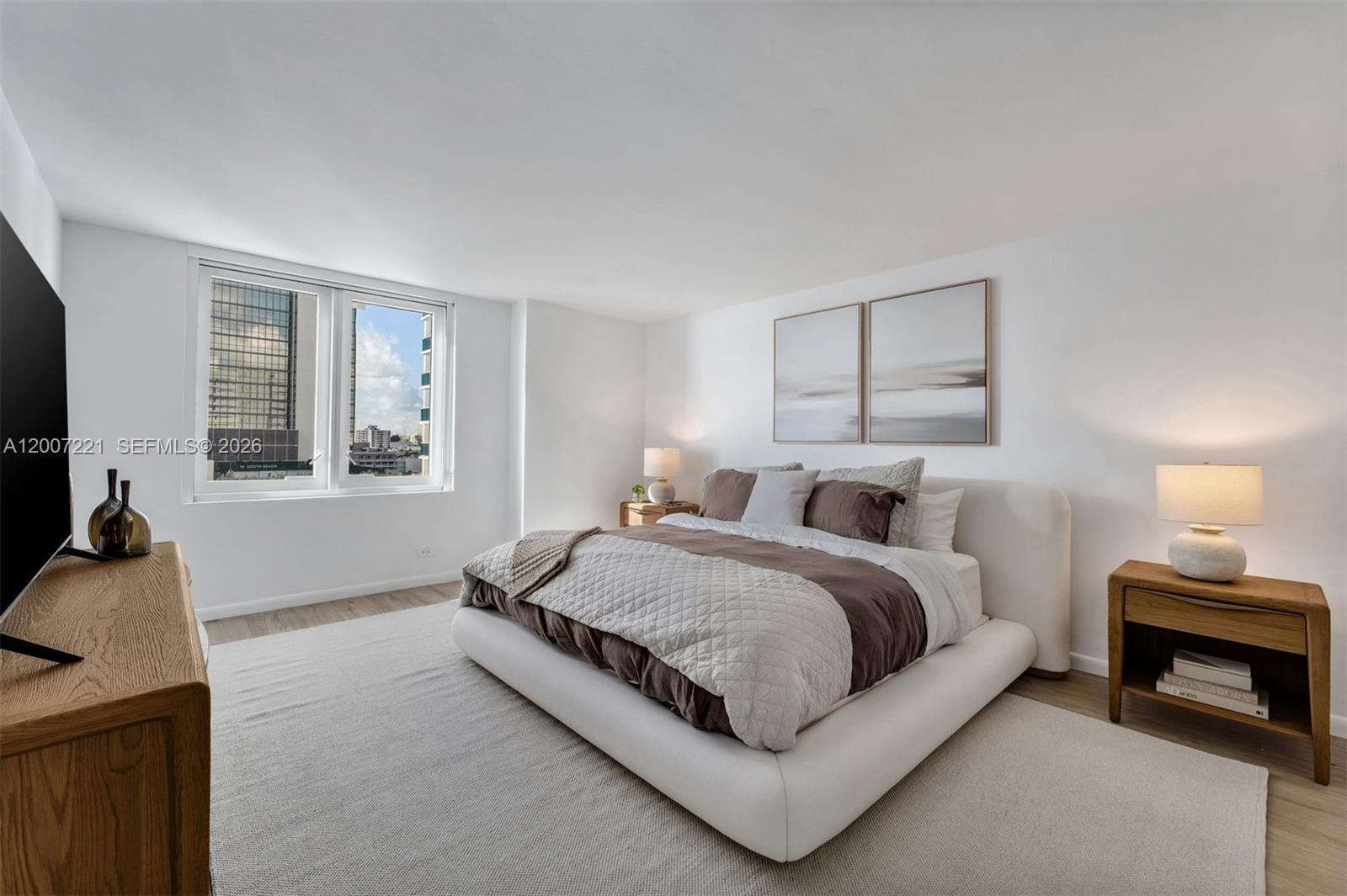 2301 Collins Avenue, Unit 902 Miami Beach, FL 33139 - Photo 19 of 22 a spacious bedroom with a bed and a window