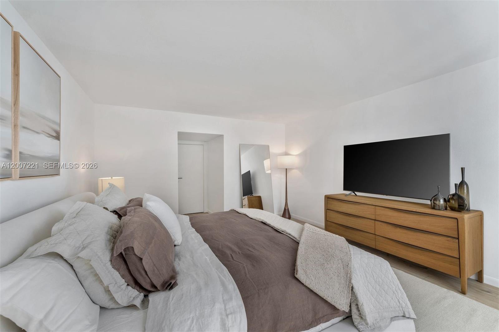 2301 Collins Avenue, Unit 902 Miami Beach, FL 33139 - Photo 20 of 22 a bedroom with a bed and a flat screen tv