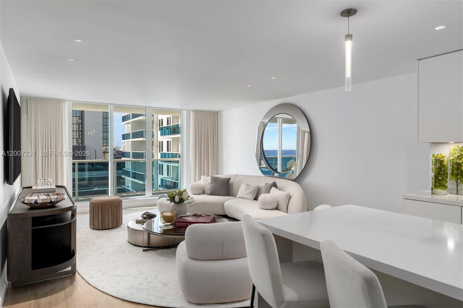 2301 Collins Avenue, Unit 902 Miami Beach, FL 33139 - Photo 3 of 22 a living room with furniture and a large window