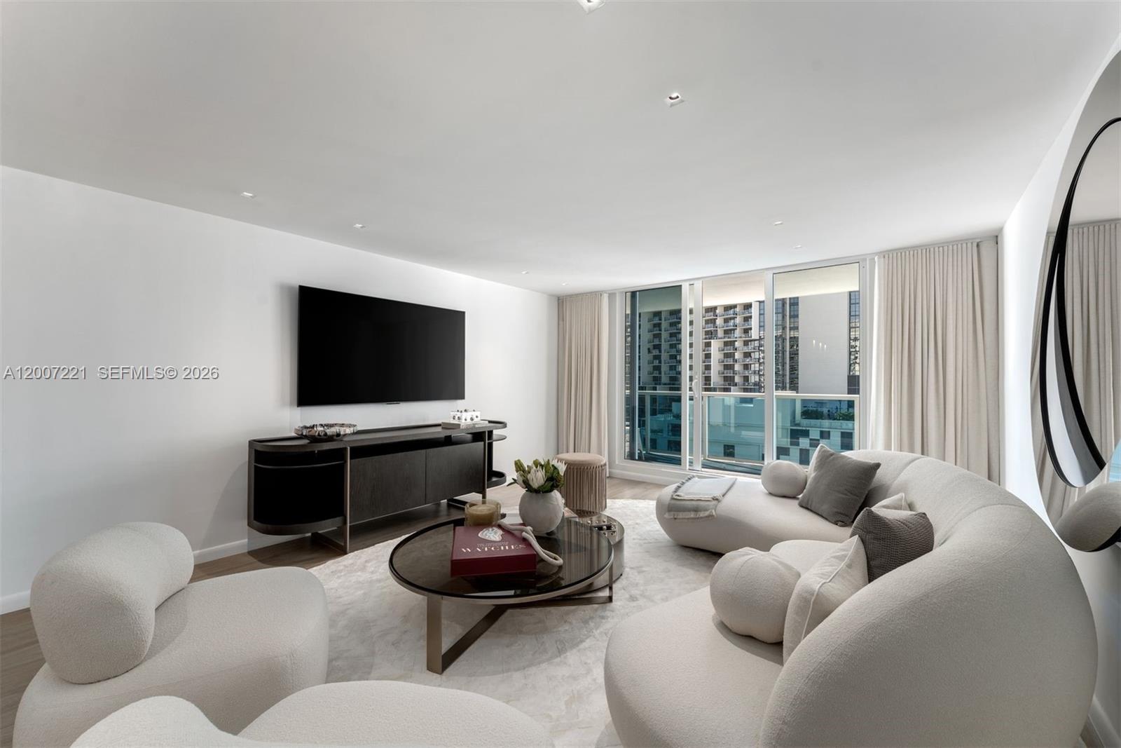 2301 Collins Avenue, Unit 902 Miami Beach, FL 33139 - Photo 10 of 22 a living room with furniture and a flat screen tv