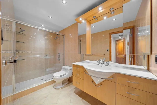 a bathroom with a double vanity sink toilet and shower