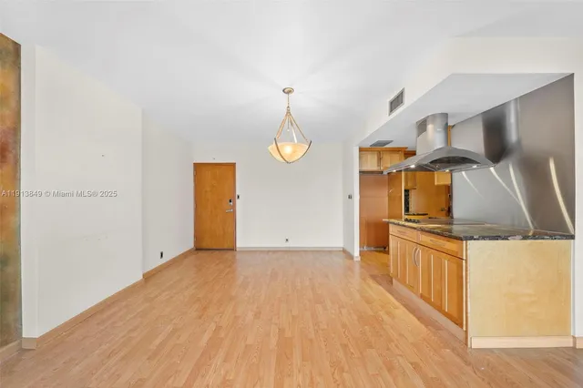 a view of a kitchen from a hallway