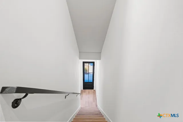 a kitchen with granite countertop a stove top oven sink and cabinets