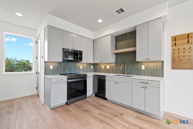 an empty room with wooden floor and a window
