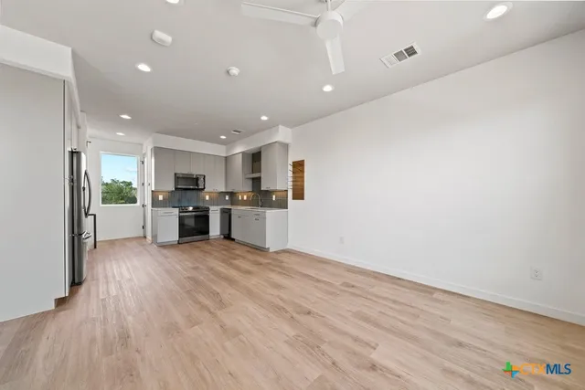 a view of hallway with wooden floor