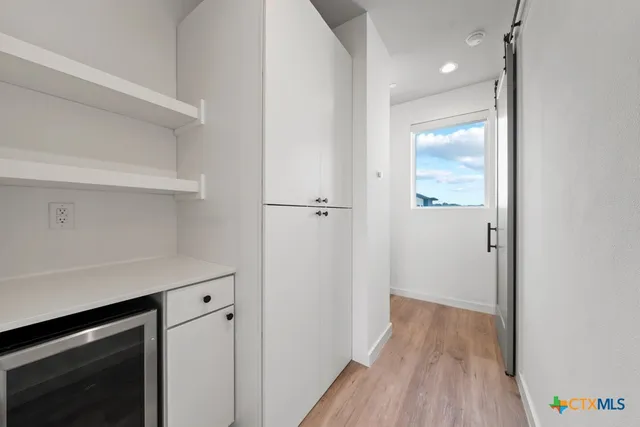 a view of hallway with wooden floor