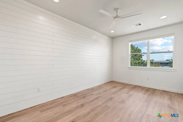 a bathroom with double vanity and a mirror