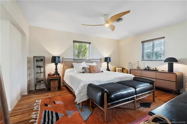 a living room with furniture a rug and a large window