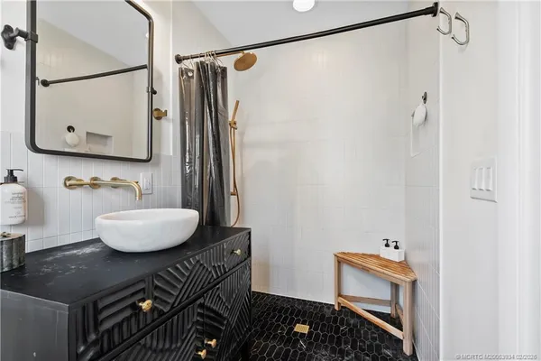 a view of a house with plants and large trees