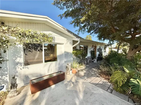 a view of a patio with a table chairs and a table and chairs