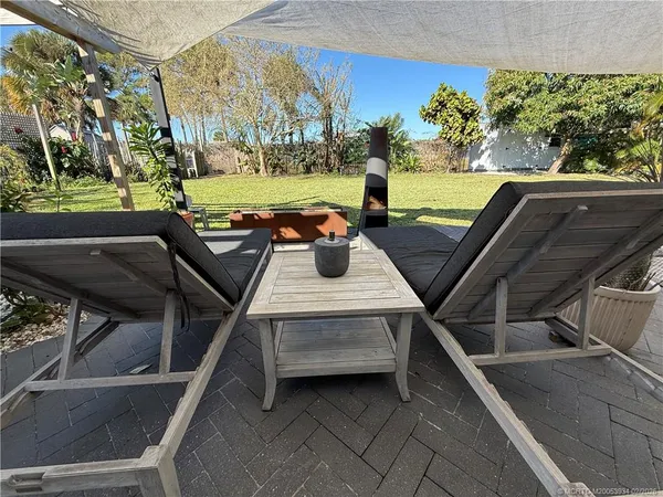 a front view of a house with swimming pool yard and outdoor seating