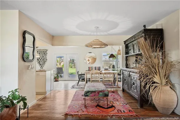 a living room with furniture kitchen view and a window