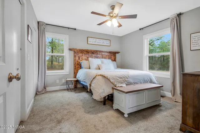 a bedroom with a large bed and a chandelier