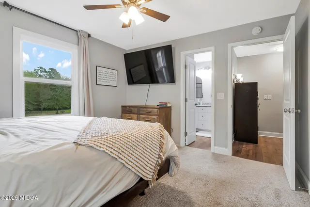 a bathroom with a granite countertop toilet a sink and a mirror