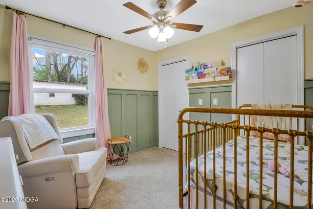 a bedroom with furniture and baby crib