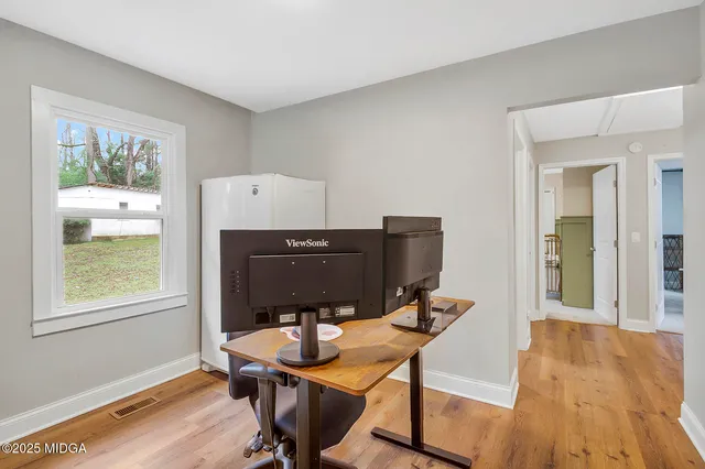 a bedroom with bed and a flat screen tv