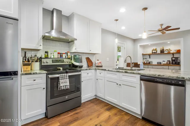 a kitchen with stainless steel appliances a refrigerator and a sink