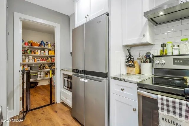 a view of a kitchen with a sink dishwasher and wooden floor
