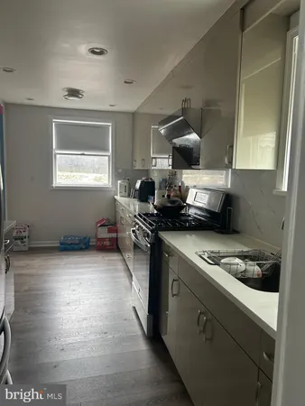 a kitchen with a stove a refrigerator and a window