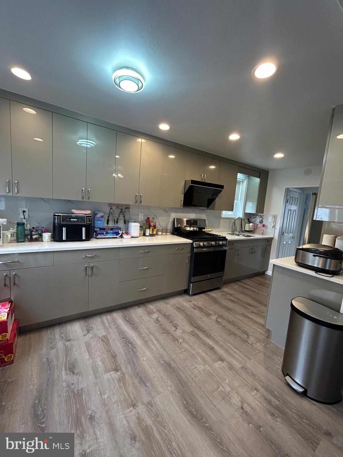 830 Pne Hl Road Philadelphia, PA 19115 - Photo 13 of 42 a kitchen with stainless steel appliances kitchen island granite countertop a stove a sink and a refrigerator