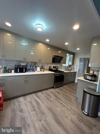 a kitchen with stainless steel appliances kitchen island granite countertop a stove a sink and a refrigerator