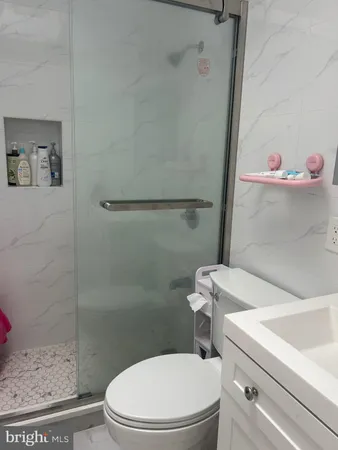 a white toilet sitting next to a bathroom sink