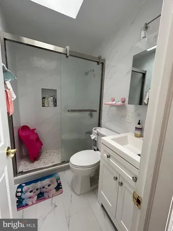 a bathroom with a sink toilet and shower