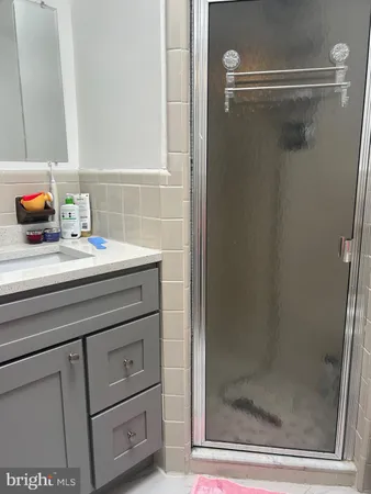 a bathroom with a sink mirror and shower