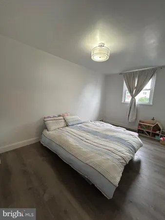 a spacious bedroom with a bed and a chandelier