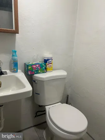 a white toilet sitting next to a bathroom sink