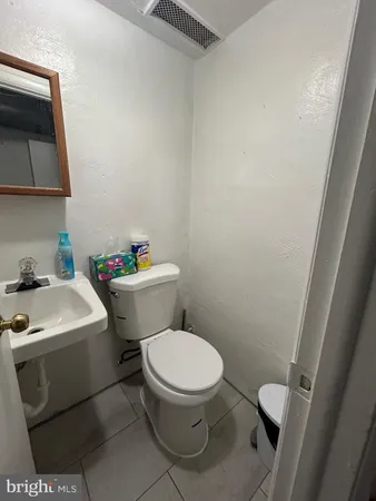 a white toilet sitting next to a bathroom sink