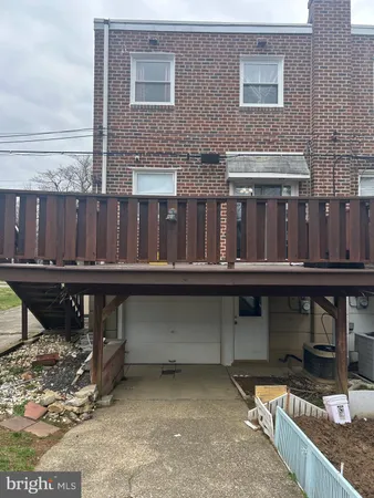 a view of house with balcony and outdoor seating