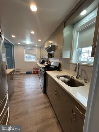 a large kitchen with stainless steel appliances granite countertop a sink and a stove