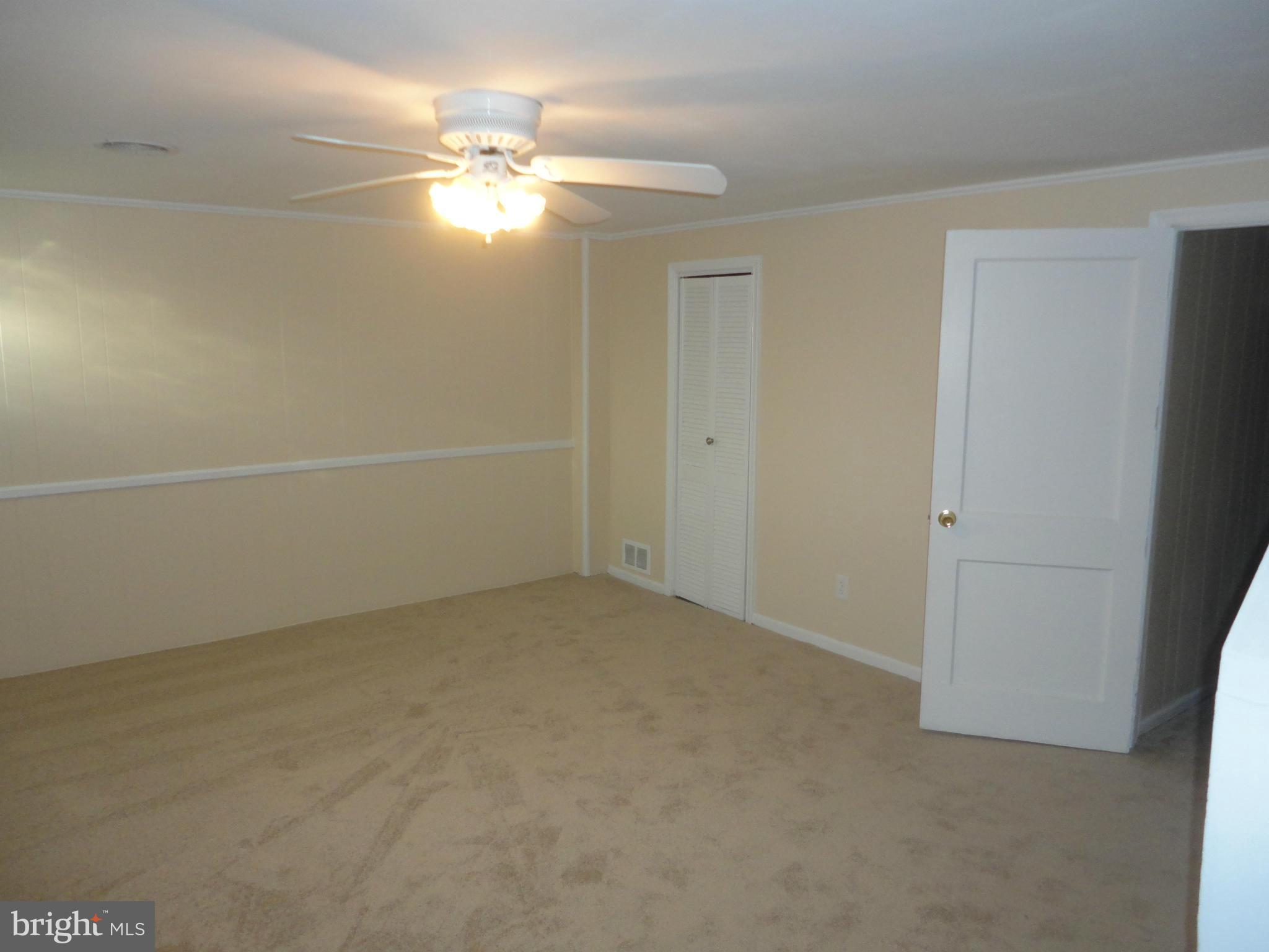 224 Stanmore Road Baltimore, MD 21212 - Photo 13 of 19 an empty room with a ceiling fan and window
