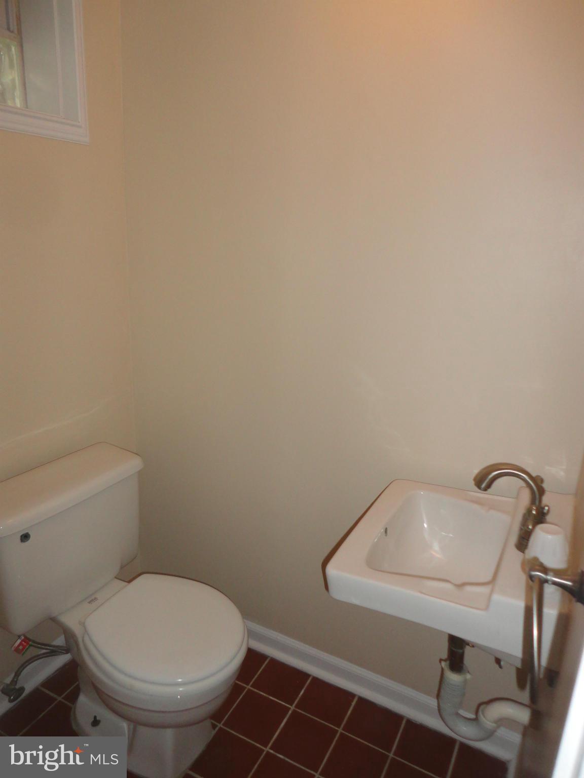 224 Stanmore Road Baltimore, MD 21212 - Photo 16 of 19 a white toilet sitting next to a white sink