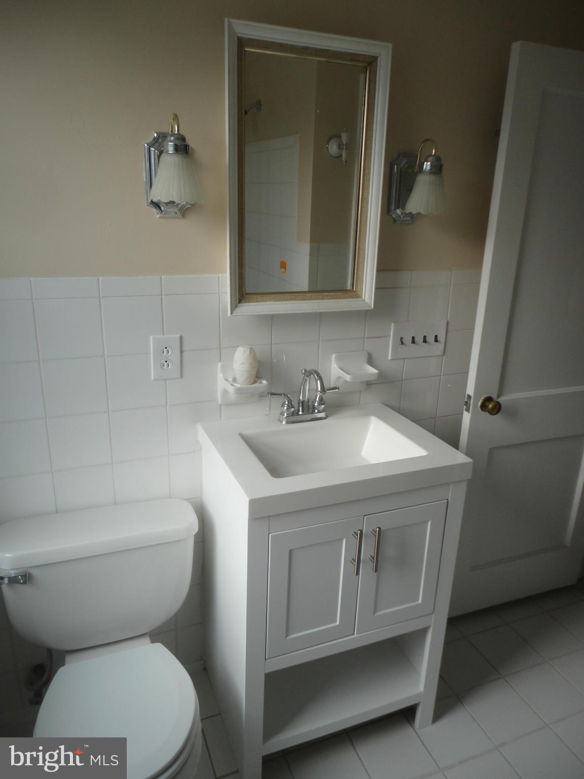 224 Stanmore Road Baltimore, MD 21212 - Photo 4 of 19 a bathroom with a sink toilet and mirror