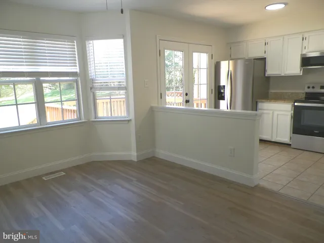 a kitchen with stainless steel appliances a refrigerator and a stove top oven