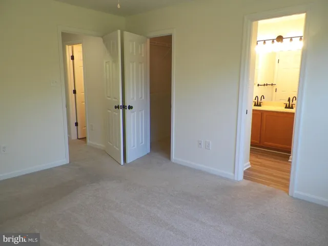 a view of a hallway with wooden floor and front door