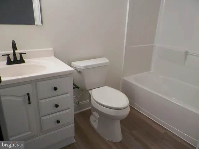 a bathroom with a sink a toilet and bathtub
