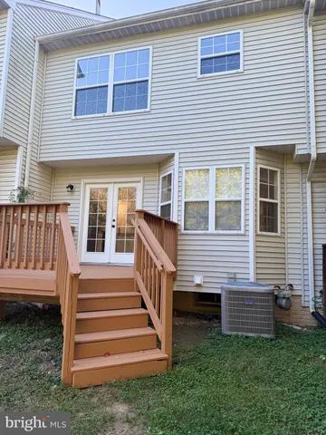 a view of a house with a yard and stairs