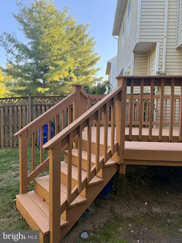 a view of a balcony with wooden floor and fence