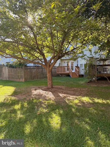 a view of a yard with a house in the background