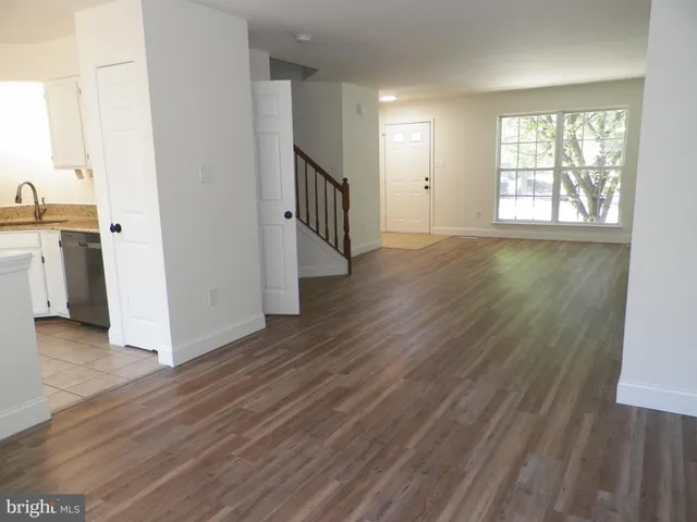 a view of a kitchen with wooden floor and a sink