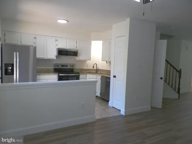 an empty room with wooden floor and a window