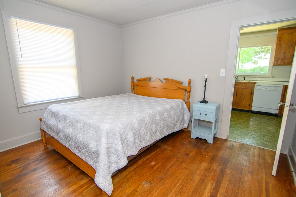 24432 Maxwell Street Parksley, VA 23421 - Photo 21 of 39 a bedroom with a bed and a table in it