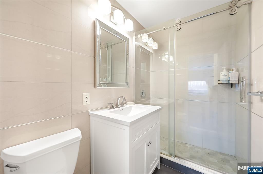 2000 Linwood Avenue, Unit 5L Fort Lee, NJ 07024 - Photo 13 of 26 a bathroom with a sink a toilet and shower