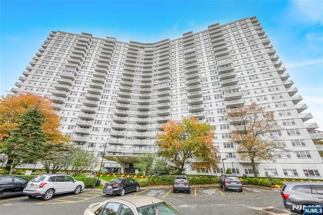 a front view of a building with parking